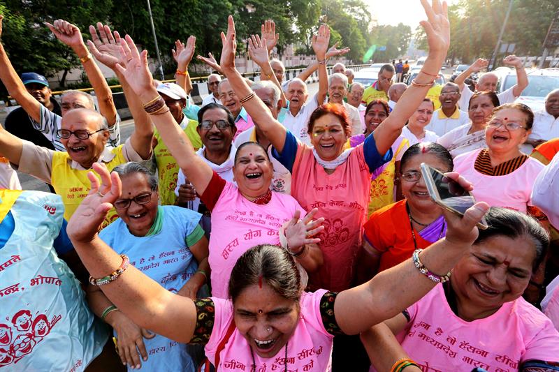 Members of various laughter clubs perform laughing exercises as they take part in a rally on the occasion of the World Laughter Day in Bhopal, India. EFE