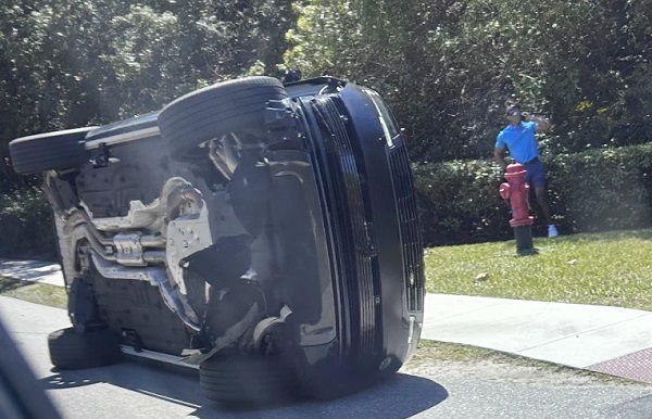 Tiger Woods a un costado de su vehículo volcado en Jupiter Island, Florida. Foto: EFE