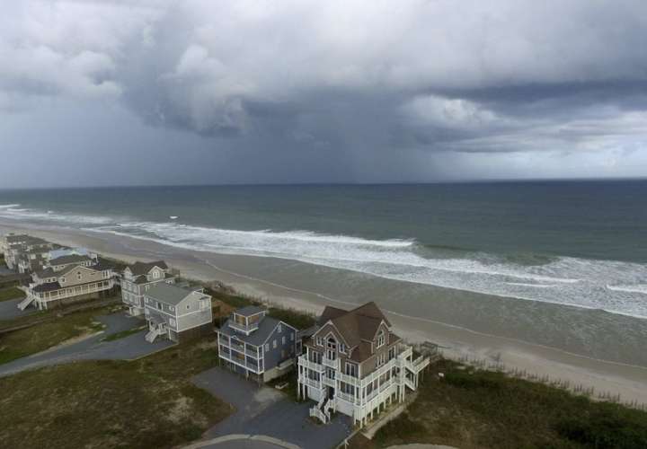 Un frente de tormenta pasa hogares en North Topsail Beach, Carolina del Norte, antes de que el huracán Florence avance hacia la costa este.  /  AP