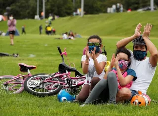 Familias disfrutan de un concierto al aire libre en un parque. EFE
