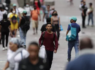 Personas caminan sin mascarillas en la Avenida Central en Ciudad de Panamá. EFE