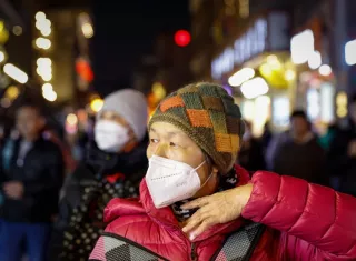 Una mujer usa una máscara KN95 en un distrito comercial de Beijing, China. EFE