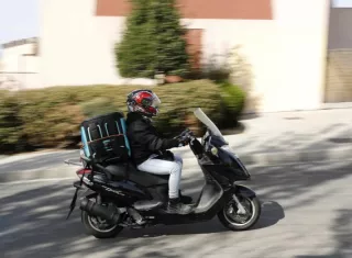 Un repartidor trabaja con su moto. EFE / Archivo