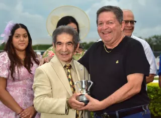 La gloria deportiva Laffit Pincay Jr. entrega el trofeo a Álvaro Díaz en la ceremonia de premiación del clásico. 