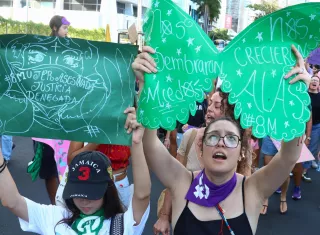Mujeres sostienen carteles durante una marcha por la conmemoración del Día Internacional de la Mujer (8M) 