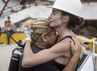 Una rescatista (d) fue captada abrazando a una mujer durante la jornada de búsqueda de sobrevivientes de los terremotos en Venezuela, en Caraballeda (La Guaira, Venezuela). Foto. EFE