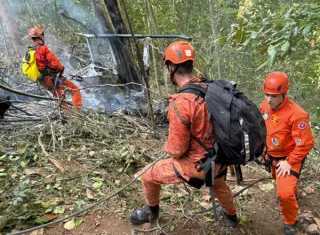 Bomberos trabajan en el lugar donde ocurrió el accidente de un helicóptero este sábado, en el Bosque de Tijuca, en Río de Janeiro (Brasil).  Foto: EFE