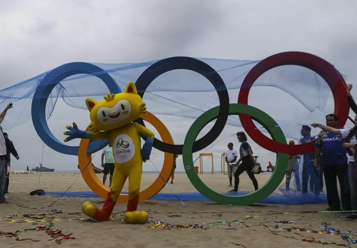 Vinicius, la mascota de los juegos que posa junto a la escultura de los anillos olímpicos que fue inaugurada por el ayuntamiento de Río de Janeiro. Foto EFE