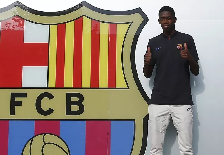 Ousmane Dembélé se fotografía ante el escudo del Barça.  Foto: EFE