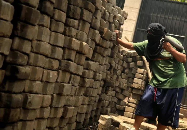 Un manifestante hace guardia en una barricada de adoquines, en Masaya (Nicaragua). EFE
