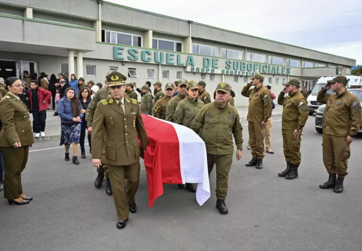 Carabineros cargando un ataúd de uno de los fallecidos tras atentado en el sur, este domingo en Concepción (Chile). EFE