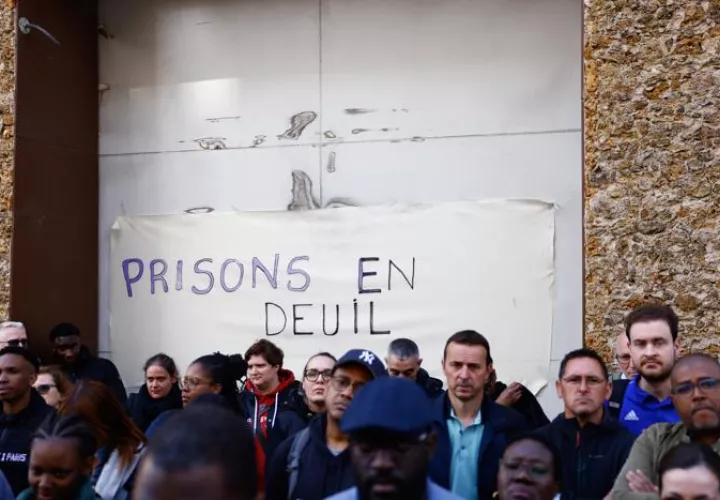 Minuto de silencio en recuerdo de los dos agentes penitenciarios asesinados este martes a las puertas de la cárcel de La Sante junto a una pancarta que dice prisiones de luto, en París, Francia, el 15 de mayo de 2024. EFE