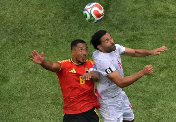 El belga Youri Tielemans (8) y el iraní Saman Ghoddos (14) disputan el balón. 